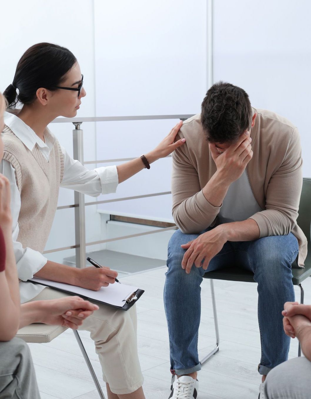 Woman Comforting a Man in a Support Group